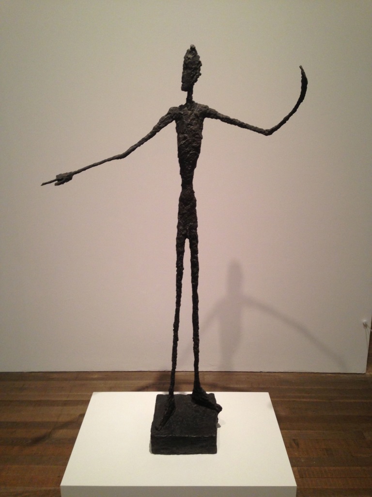 This beautiful re-imagining of the human form by Alberto Giacometti shows a man standing on an iron square, mounted on a bigger, woooden square